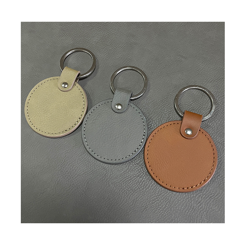 Laserbare ronde sleutelhangers van kunstleer met geoliede rand Laserbare ronde sleutelhangers van kunstleer met geoliede rand