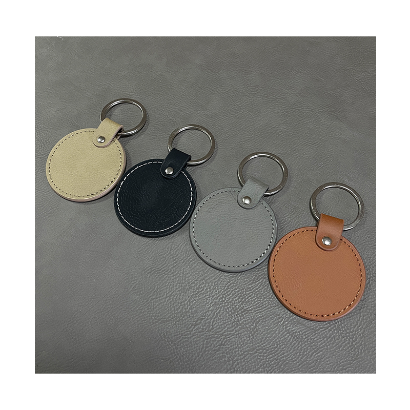 Laserbare ronde sleutelhangers van kunstleer met geoliede rand Laserbare ronde sleutelhangers van kunstleer met geoliede rand