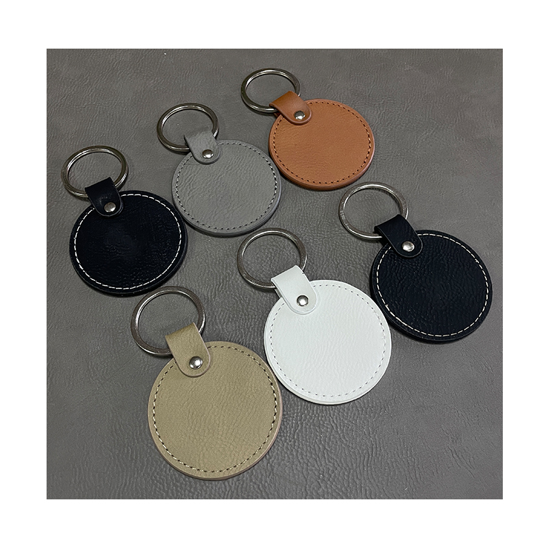Laserbare ronde sleutelhangers van kunstleer met geoliede rand Laserbare ronde sleutelhangers van kunstleer met geoliede rand