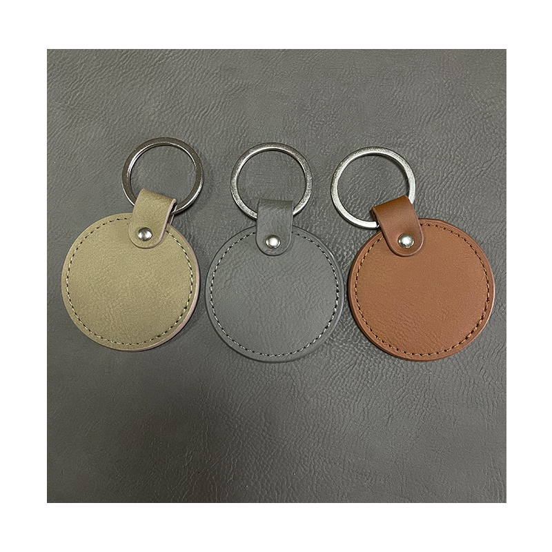 Laserbare ronde sleutelhangers van kunstleer met geoliede rand Laserbare ronde sleutelhangers van kunstleer met geoliede rand