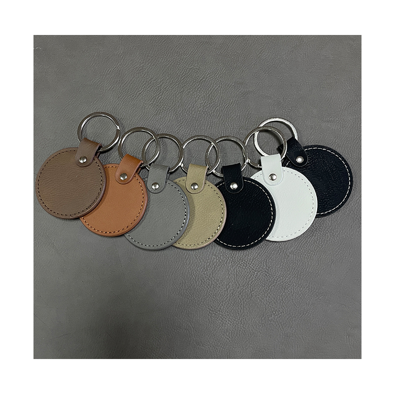 Laserbare ronde sleutelhangers van kunstleer met geoliede rand Laserbare ronde sleutelhangers van kunstleer met geoliede rand