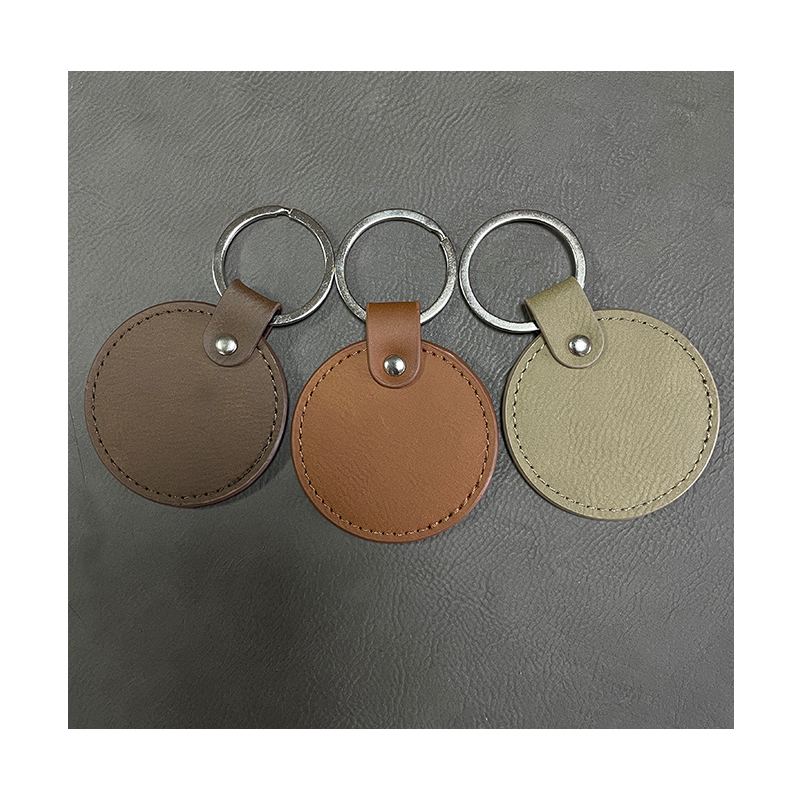 Laserbare ronde sleutelhangers van kunstleer met geoliede rand Laserbare ronde sleutelhangers van kunstleer met geoliede rand
